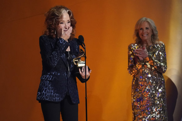 Bonnie Raitt accepts the award for song of the year for Just Like That at the 65th annual Grammy Awards. First Lady Jill Biden looks on from right.