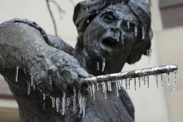 Icicles hang from a statue in downtown Austin, Texas, during a winter storm.