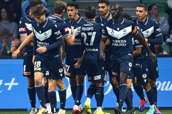 Nishan Velupillay of Melbourne Victory and his teammates celebrate the opening goal.