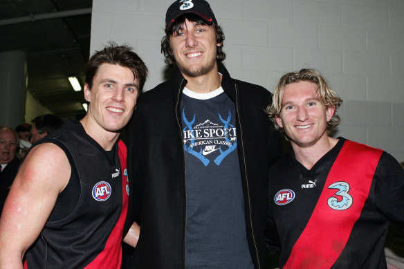 Andrew Bogut with Essendon greats Matthew Lloyd and James Hird in 2005.