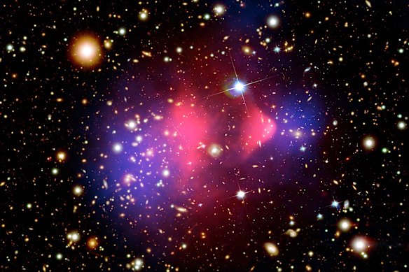 The Bullet Cluster, a pair of galaxy clusters that collided. Normal matter is shown in pink, suspected dark matter in the cluster shown in blue. This observation has provided one of the clearest direct examples of dark matter.