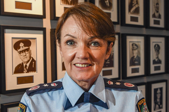 NSW Police Commissioner Karen Webb in front of pictures of commissioners past – all male.