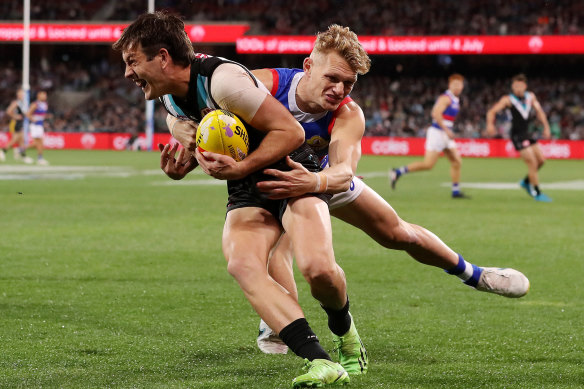 Adam Treloar tackles Zak Butters.