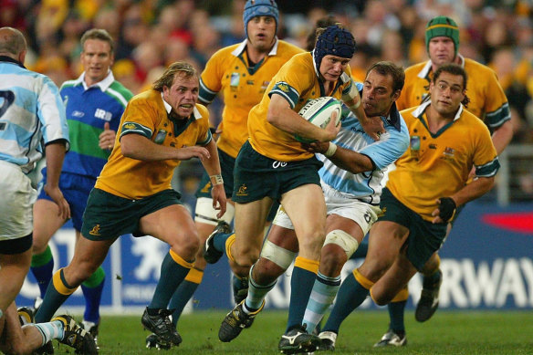 Stephen Larkham breaking the line for the Wallabies with current Rugby Australia CEO Phil Waugh in pursuit