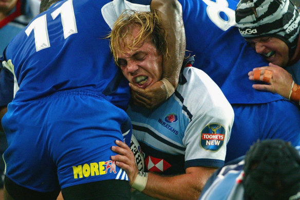 Phil Waugh in battle for the Waratahs against the Blues in 2004.