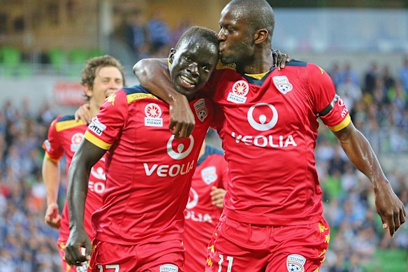 Socceroo Awer Mabil, left, is kissed by teammate Bruce Djite after scoring for Adelaide United in 2014.