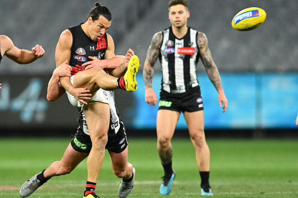 Dylan Shiel of the Bombers gets a kick away against Collingwood on Friday night.