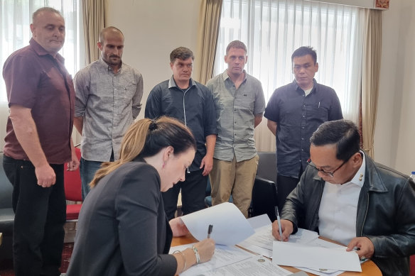 Martin Stephens, Michael Czugaj, Scott Rush, Matthew Norman and Si Yi Chen look on as Australia and Indonesia sign an agreement for their return home.
