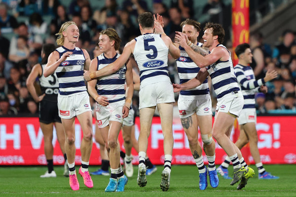 Geelong’s Jeremy Cameron (No.5) celebrates a goal with teammates.