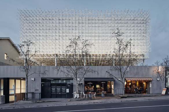 The elevated cube appears fairly rudimentary from the street.