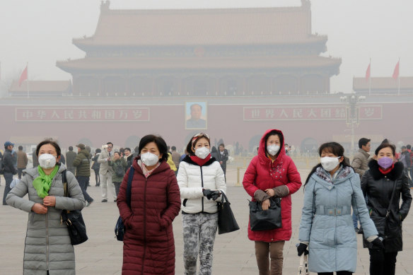 Visitors to Tiannanmen Square in Beijing wear face masks against smog, not COVID-19. With strong public demand to continue battling China’s choking air pollution, some green policies also are likely to be popular at home and reduce social pressure the government sees as a threat.