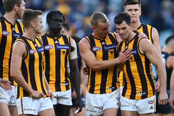 Hawthorn players check on teammate Jaeger O’Meara last week.