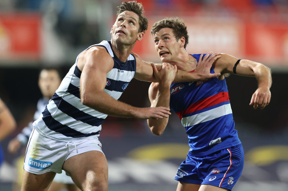 Tom Hawkins takes on Josh Dunkley in Geelong's win over the Bulldogs on Friday night. 