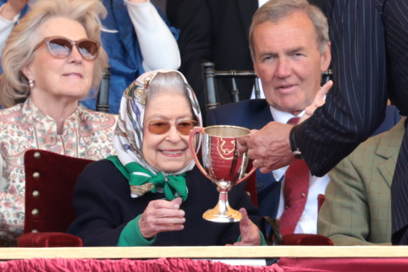 Queen Elizabeth II receives the winners cup.