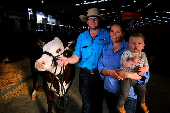 Kierin and Nikki Martin, pictured with 14-month-old son Riley, showcase the Hereford cattle at the Melbourne Royal Show.