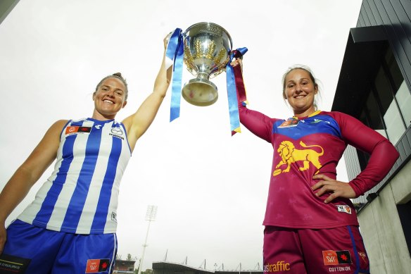 North Melbourne’s Emma Kearney and Brisbane’s Bre Koenen with the trophy ahead of Sunday’s AFLW grand final.