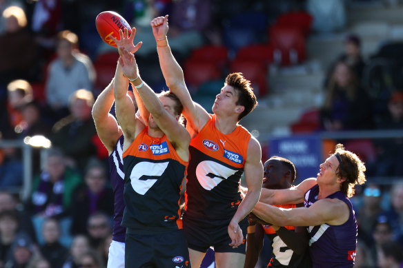 Giants duo Sam Taylor and Toby Greene go up for the footy.