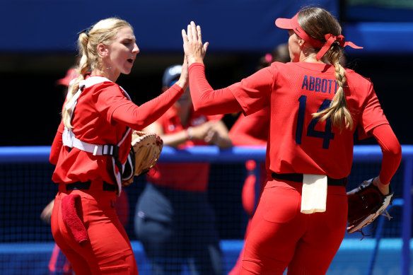 Aubree Munro and Monica Abbott share a moment after a successful third inning.