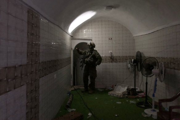 A soldier standing in an underground compound where the Israeli military said hostages had been held by Hamas.