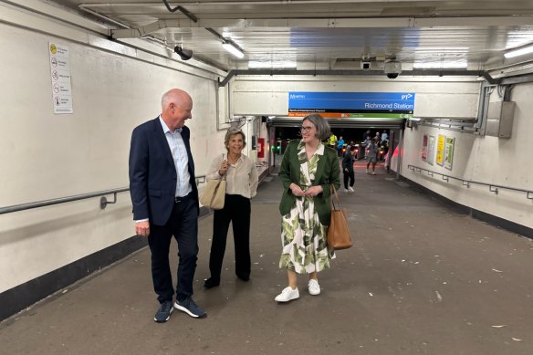 AFL chairman Richard Goyder, his wife Janine Goyder, and Coles CEO Leah Weckert at Richmond train station.