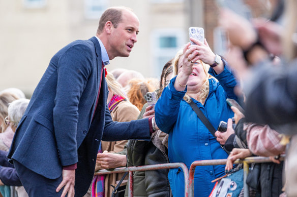 William, Prince of Wales poses for photos with the public as he arrives to visit “The Street”  during their charity visit to Scarborough.
