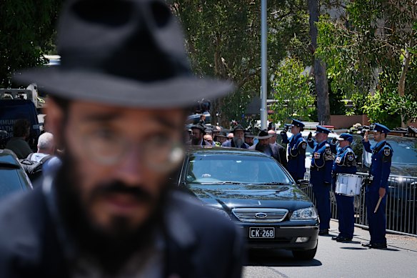 The vehicle carrying the coffin of Rabbi Eli Schlanger leaves the Chabad of Bondi Synagogue.
