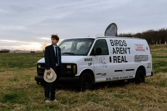 Peter McIndoe, the 23-year-old creator of the Birds Aren’t Real movement, with his van in Fayetteville, Arkansas. 