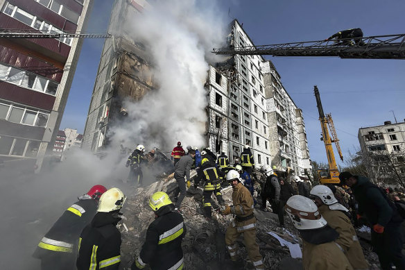 Firefighters work at an apartment building destroyed by a Russian attack in the town of Uman, around 215km south of Kyiv.