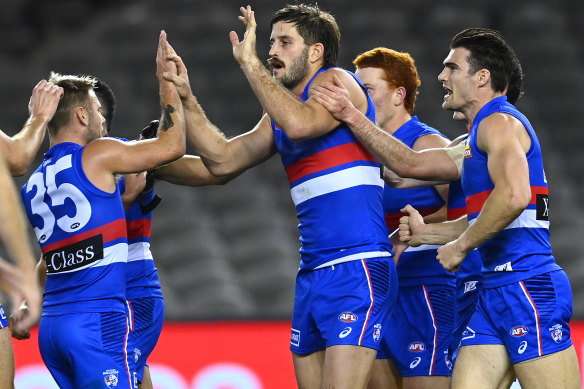 Josh Bruce celebrates with Bulldogs teammates after scoring on Saturday night. 