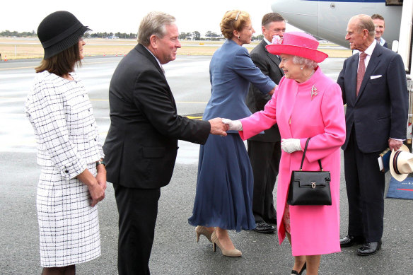Then-WA premier Colin Barnett welcoming The Queen and Prince Philip on their arrival at Perth International Airport on October 26, 2011.