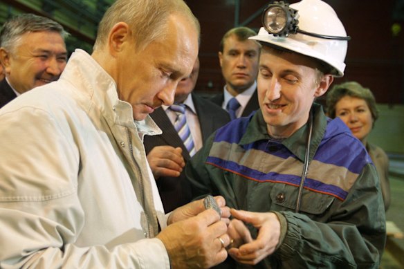 Russian President Vladimir Putin examines an uncut chunk of diamond during a visit to Siberia in 2009.