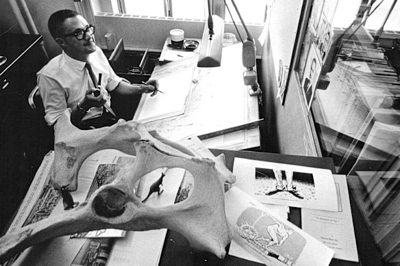 Pat Oliphant at his desk at The Denver Post in the '60s.