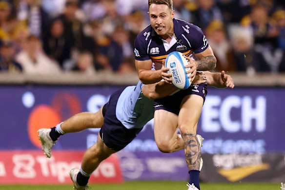 Corey Toole of the Brumbies is tackled by the Waratahs