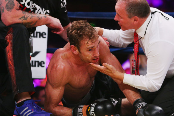 Shane Tuck on the ground after being knocked out during a boxing match after his retirement from AFL.