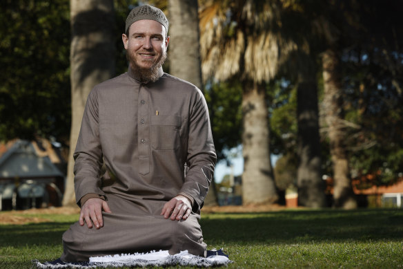 Myles Hembrow at Enmore Park with his prayer mat and wearing a thobe, which is typically seen at mosques during Eid.