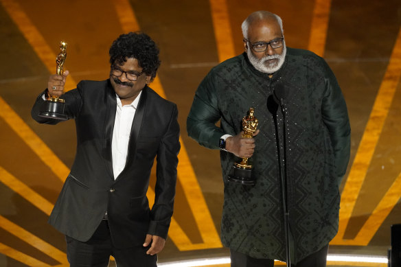 M.M. Keeravaani (right) and lyricist Chandrabose accept the award for best original song for Naatu Naatu from RRR.