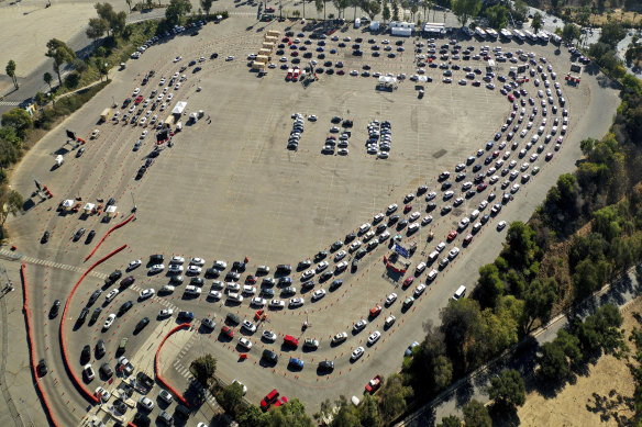 Drivers queue at a COVID-19 testing site in a parking lot at Dodger Stadium in Los Angeles this week.