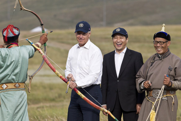 Then US vice president Joe Biden, standing next to then Mongolian prime minister Sukhbaatar Batbold, tries archery in Mongolia.
