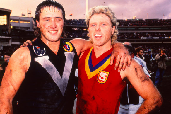 Tony Lockett and Dermott Brereton (having swapped guernseys with an opponent) after Victoria’s win over South Australia in 1989.