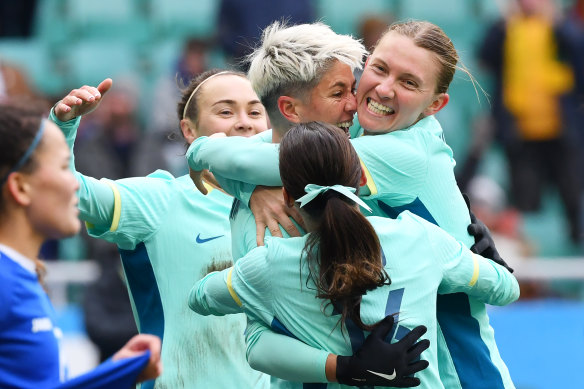 Michelle Heyman is swarmed by Matildas teammates after her goal.