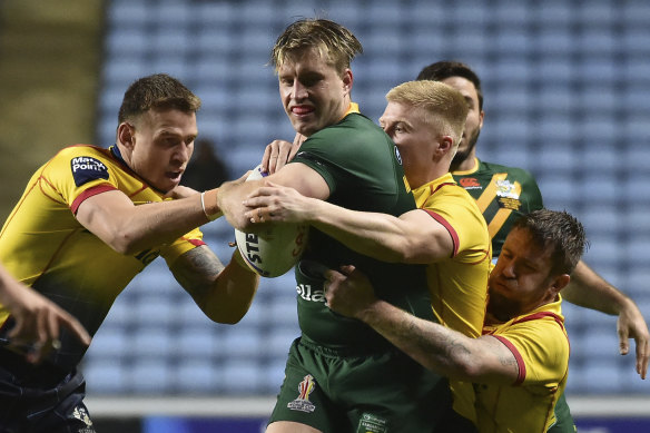 Cameron Munster is tackled by Scotland’s players during Australia’s big win.
