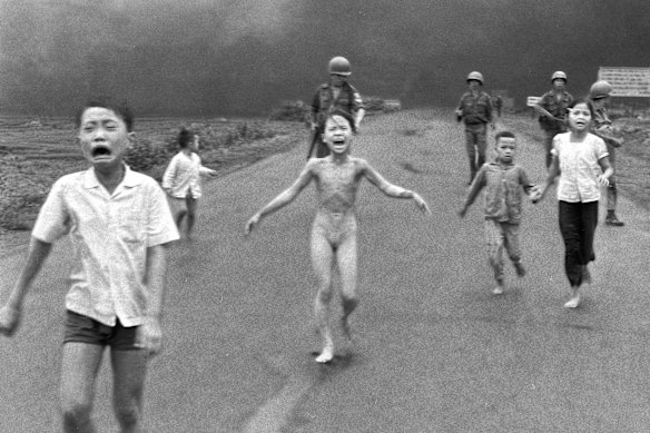 Terrified children, including nine-year-old Kim Phuc (centre), run down Route 1 near Trang Bang after an aerial napalm attack on suspected Viet Cong hiding places on June 8, 1972.