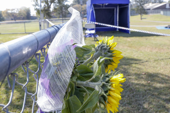 Flowers are seen near a crime scene at Frascott Park in Varsity lakes on Thursday.