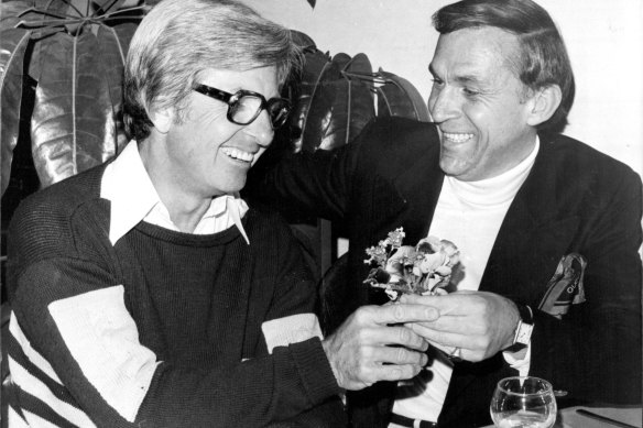 A peace posey? Rogers and John Laws at lunch to supposedly end their long feud in 1977.