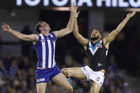 Todd Goldstein had a masterful game. Here he leaps for the ball with Port's Paddy Ryder.