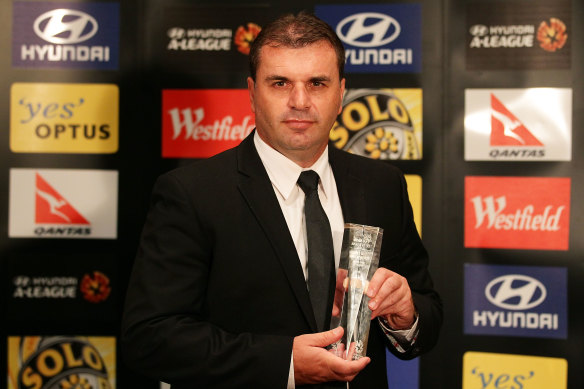 Postecoglou with the A-League Coach of the Year award for 2010-11 during his time with Brisbane Roar.