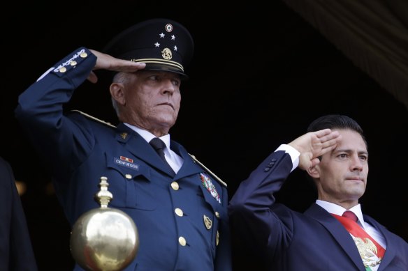 Former defence secretary General  Salvador Cienfuegos (left) and  Mexico's former president Enrique Pena Nieto, salute during the annual Independence Day military parade in Mexico City's main square. 
