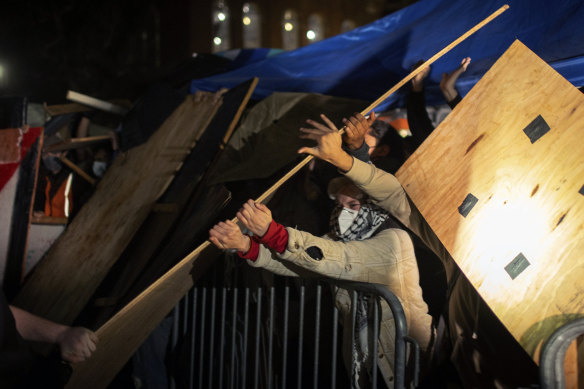 Demonstrators clash at a pro-Palestinian encampment at UCLA early Wednesday in Los Angeles. 