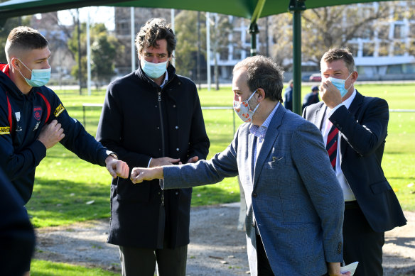 Martin Pakula fist bumps with Demon Adam Tomlinson at Monday’s announcement for upgrades at Gosch’s Paddock.