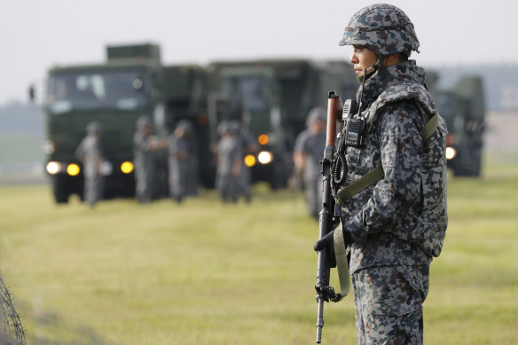 A Japanese Air Self-Defence Force member stands guards as the force demonstrates PAC-3 surface-to-air interceptors at the US Yokota Air Base in Fussa, near Tokyo.